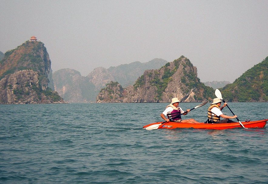 Kayaking among the limestone islands of Ha Long Bay on a Victoria Tour cruise