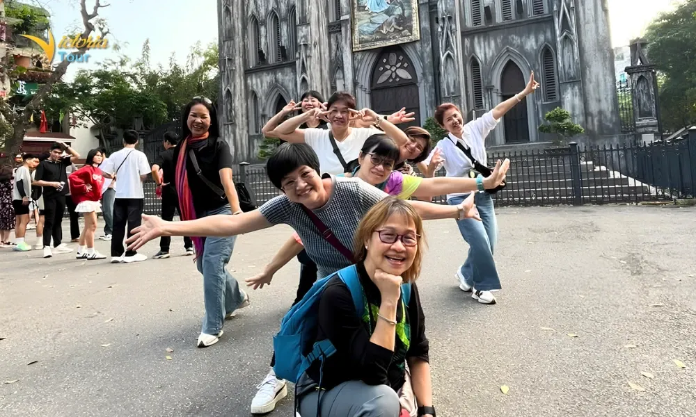 Family group visiting St. Joseph's Cathedral in Hanoi, Vietnam