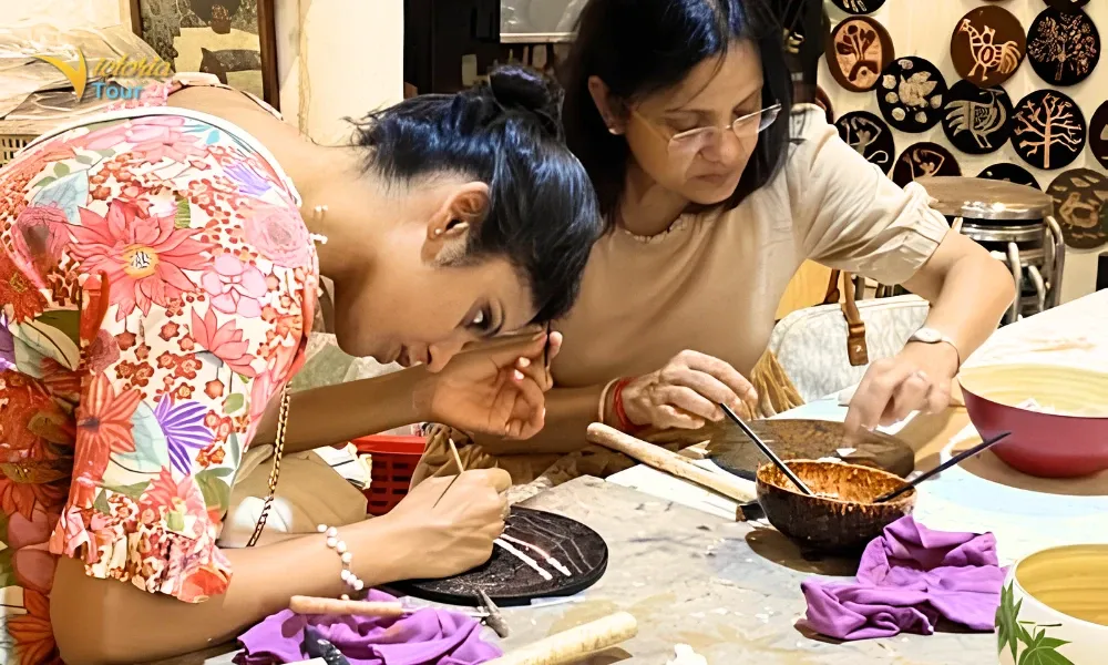 Vietnamese artisan demonstrating traditional craft techniques in a workshop